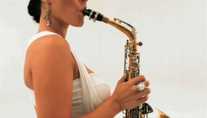 Big Tits Latina Blows A Funky Sax Solo GIF